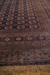 Traditional geometric borders and soft fringe of a vintage hand-knotted Bokhara carpet.