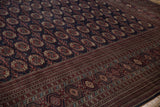 Close view of the lustrous wool pile and detailed geometric border of a vintage Bokhara rug.