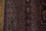 Intact selvage and fringe on a vintage Bokhara rug with geometric gul medallion borders.