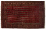 Fine vintage Bokhara carpet showing a lustrous cherry red field with repeating navy and ivory gul medallions.