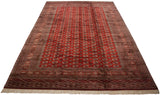 Angled perspective on a vintage Bokhara carpet showing the lustrous wool and repeating gul motif.