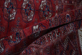 A folded view revealing the plush, high-sheen wool pile of a vintage Bokhara rug.