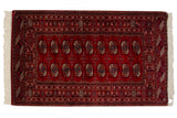 Fine vintage hand knotted Bokhara rug, cherry red field, geometric gul medallions, 3' x 5'.