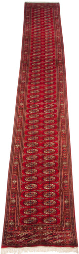 Vintage Bokhara runner rug with repeating cherry red gul medallions, chestnut borders, and white fringe.