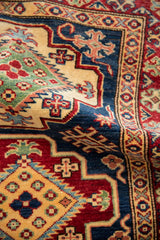 Close-up of the soft low wool pile, showing geometric floral patterns and dynamic luster.