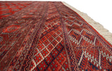 A low-angle view showing the plush wool pile and intricate geometric border of a fine Bokhara rug.