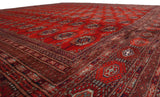 A low perspective across the lustrous red pile, showing the traditional Bokhara gul pattern.