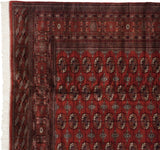 Original side cord selvage and clean fringe on the corner of a fine vintage red Bokhara carpet.