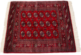 The tight, fine weave and traditional gul medallions of a vintage Pakistani Bokhara rug.
