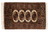 Vintage Bokhara rug with repeating geometric guls in copper, bronze, and navy on an ivory field.