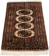 Vintage Bokhara rug mat viewed from an angle, showing the plush wool pile and geometric gul design.