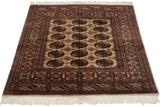 Vintage Bokhara rug with intricate camel and brown geometric borders and plush fringe.