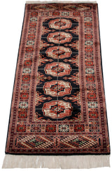 Rust, black, ivory geometric gul medallions and border detail on a vintage Bokhara runner.