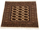 High-sheen wool pile of a vintage fine Bokhara rug with repeating gul motifs, viewed from an angle.