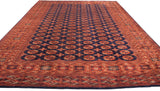 Plush navy field with repeating Bokhara gul motifs, framed by patterned copper rust borders.