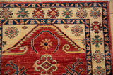 Expressive floral motifs in the ivory and cobalt blue borders of a hand-knotted Pakistani rug.
