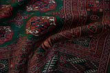 Soft folds of a vintage Bokhara rug displaying its plush, lustrous wool pile and fine weave.