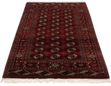 Angled perspective of a vintage Bokhara rug highlighting its lustrous pile and gul medallions.