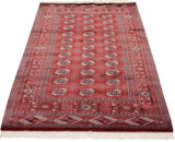Long view of a vintage Bokhara rug highlighting columns of geometric gul medallions.