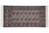 The tight, fine weave and detailed gul medallions of a silk-like vintage Pakistani Bokhara rug.