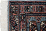 A vintage Bokhara rug corner with plush pile, intact side selvage, and clean ivory fringe.