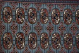 Finely woven gul medallions and plush wool pile of a vintage denim blue Bokhara rug.