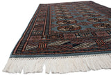 Low angle view showing the dynamic sheen and plush wool pile of a vintage Pakistani Bokhara rug.