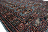 Angled close-up of a vintage Bokhara rug highlighting its fine weave and plush, lustrous pile.