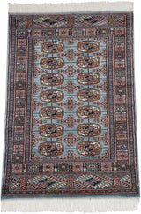 The lustrous wool pile and repeating gul medallions of a vintage Pakistani Bokhara rug.