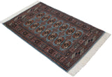 Angled view of a vintage fine Bokhara rug showcasing its full geometric gul pattern and ivory fringe.