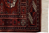 Fine weave and geometric gul motifs on the corner of a wine red vintage Bokhara rug mat.