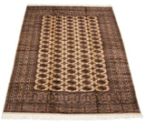 Angled perspective highlighting the high sheen on a vintage Bokhara carpet with geometric gul motifs.