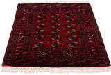 Vintage Bokhara rug corner: detailed geometric borders, cherry red field, original selvage.