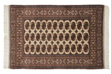 Vintage Fine Bokhara rug with repeating gul medallions in rust and coffee brown over a clean ivory field.