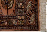 Original cream fringe and dusty rose patterned side edge of a vintage Bokhara rug.