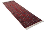 Fine vintage Bokhara rug runner with geometric gul medallions in navy and ivory on a cherry red field.