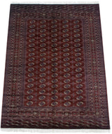 Vintage Bokhara carpet in wine red, detailed gul medallions, fine weave, and luster.