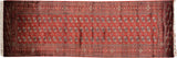 Traditional Bokhara runner rug featuring rows of gul medallions on a lustrous cherry red wool pile.