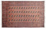Plush Bokhara carpet featuring detailed gul medallions in dusty rose and navy, displaying high sheen.