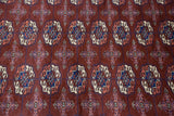Detailed geometric floral gul medallions in wine red, cobalt blue, and ivory pile.