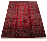 An angled view down the length of a fine Bokhara carpet, highlighting the wool pile's high sheen.