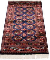Angled perspective of a vintage Bokhara rug, showing its plush wool pile and lustrous sheen.