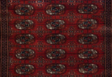 A plush, silk-like wool pile showing the detailed weave of a vintage Bokhara rug runner.