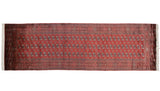 Full view of a fine Bokhara runner displaying its precise multi-column pattern of traditional gul medallions.