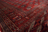 Angled view of the intricate geometric borders and gul medallions on a fine Bokhara rug runner.