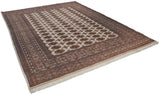 Angled view of a vintage Bokhara carpet showing its lustrous pile and geometric gul pattern.