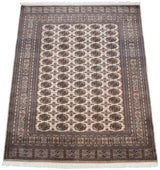 Fine Bokhara rug corner: beige field, brown gul medallions, detailed geometric borders.