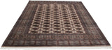 White fringe and detailed geometric borders of a hand-knotted vintage Bokhara carpet.