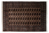 Vintage Bokhara carpet with fine weave, beige field, repeating bronze navy gul medallions.