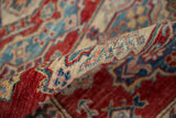 Soft wool pile, geometric Caucasian motifs in cherry red, ivory, and indigo blue.